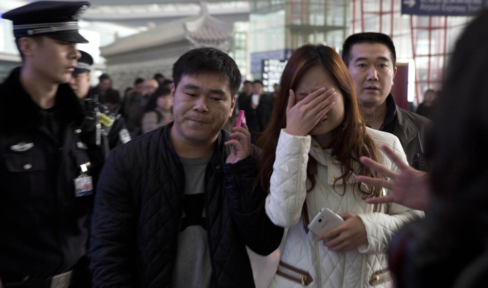 Passengers’ friends and family arrive Saturday at the international airport in Beijing for news of a Malaysia Airlines plane that was reported missing on a flight from Kuala Lumpur.