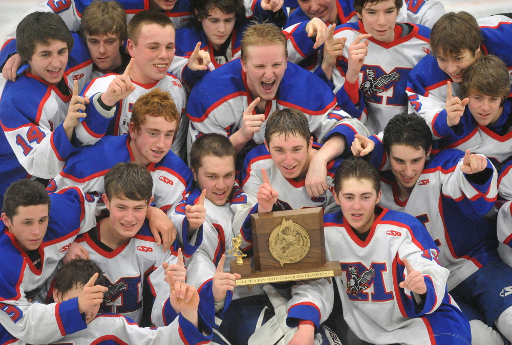 Staff photo by Michael G. Seamans The Messalonskee High School hockey team celebrates their State Championship after defeating Gorham High School 6-1 in the Class B state championship game at the Androscoggin Bank Colisee in Lewiston on Saturday.