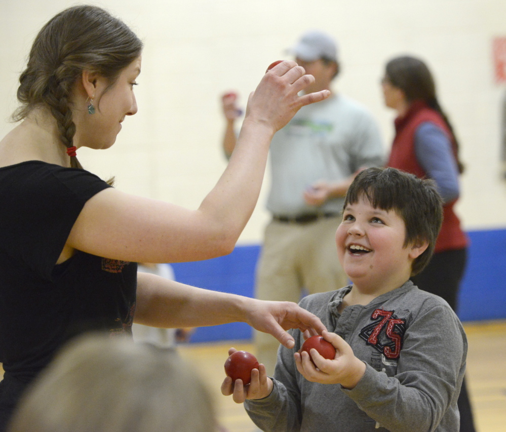 Martha Fournier shows Kyle Brown, 8, of Gorham how to juggle. Above left, Kyle gets the hang of it.