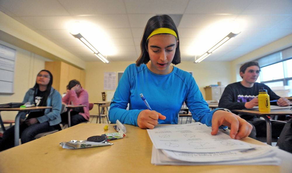 The pace-setter: Ursula Hebert-Johnson, 17, a senior at Waterville Senior High School, works on a math equation Wednesday during math team practice.