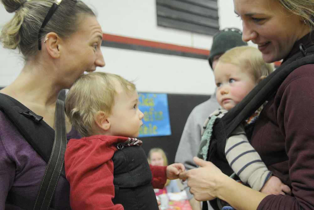 HEARTS FOR EZRA: Sam Dix, left, greets his buddy, Oliver Paisley, Sunday, during the Hearts for Ezra Auction and Fundraiser at Hall-Dale High School in Farmingdale. Dix attended with his mother, Sarah Dunckel, and father, Tom Dix. Oliver rolled in with his parents, Jen and Mark Paisley. Money raised assists in researching a cure for spinal muscular atrophy.