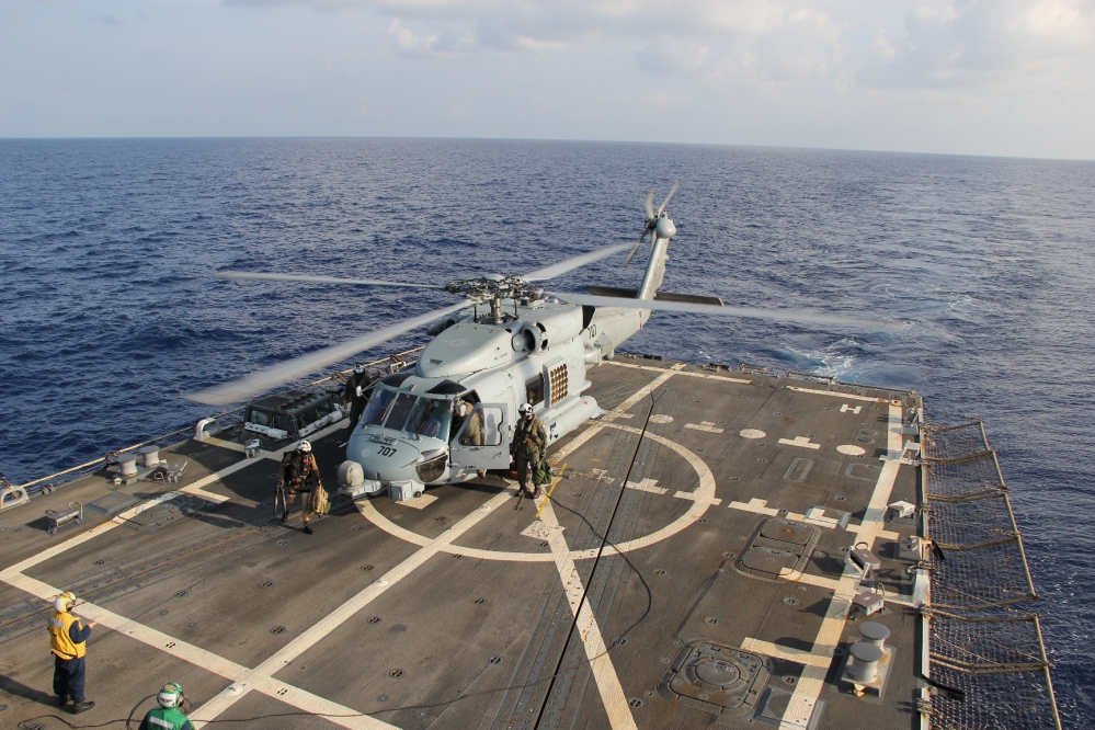 A U.S. Navy helicopter lands aboard Destroyer USS Pinckney during a crew swap before returning to a search and rescue mission for the missing Malaysian airlines flight MH370 in the Gulf of Thailand on Sunday. Scores of ships and aircraft from several countries continued to hunt for the plane and the 227 passengers and 12 crew members on board.