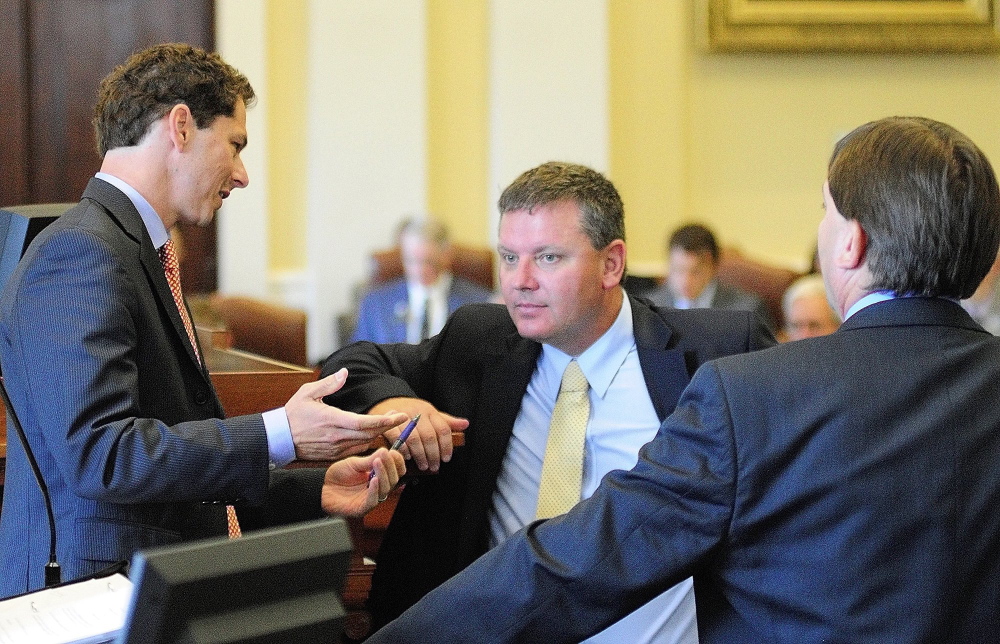 Senate President Justin Alfond, left, confers with Senate leaders Sen. Michael Thibodeau, R-Winterport, and Sen. Troy Jackson, D- Allagash, during a special session on Thursday August 29, 2013 in the State House in Augusta.
