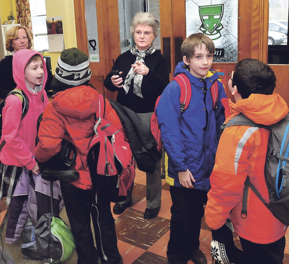 GROWING SCHOOL: Mount Merici Academy Principal Susan Cote directs students leaving during an early-release day Wednesday at the Waterville private school.