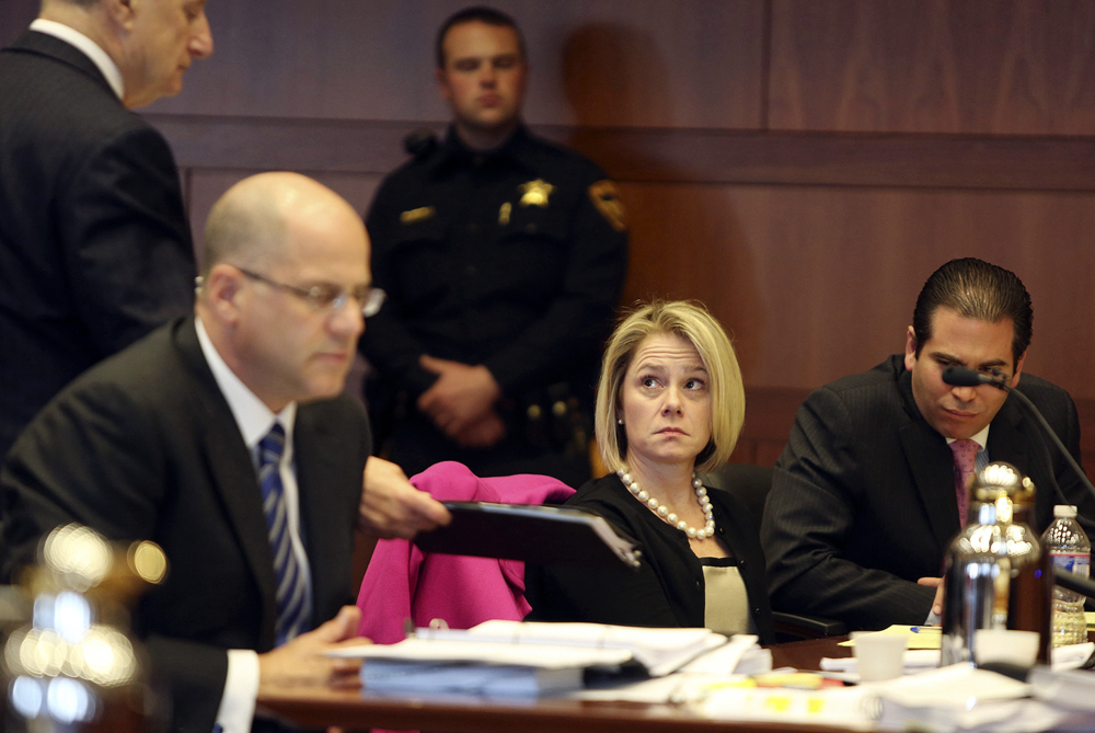 Bridget Kelly, New Jersey Gov. Chris Christie’s former deputy chief of staff, looks at her attorney Michael Critchley, left, during a hearing Tuesday in Trenton, N.J. Attorneys for Kelly and Bill Stepien, the other ex-Christie loyalist fighting a subpoena, were in court to try to persuade a judge not to force them to turn over text messages and other private communications to New Jersey legislators investigating the political payback scandal ensnaring Christie’s administration.