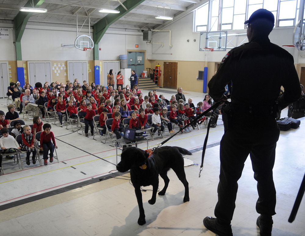 As seen on TV: District Game Warden Kristopher MacCabe talks Wednesday to St. Michael School students in Augusta. The Monmouth native is featured in the television show “North Woods Law.”