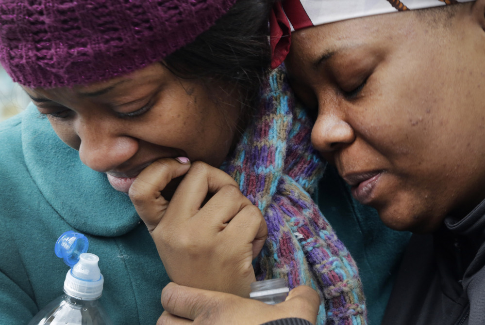 Alecia Thomas, left, is comforted by a friend, Shivon Dollar, after she lost her home following an explosion that leveled two apartment buildings in the East Harlem neighborhood of New York City on Wednesday.
