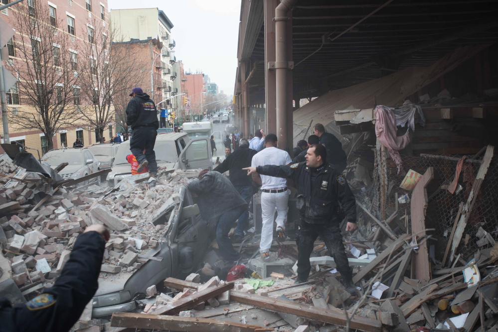 Police respond to the scene of an explosion that leveled two apartment buildings in the East Harlem neighborhood of New York on Wednesday.