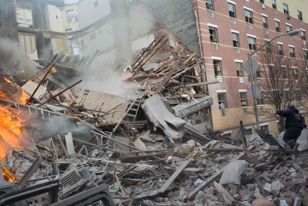 Emergency workers respond to the scene of an explosion that leveled two apartment buildings in the East Harlem neighborhood of New York City on Wednesday.