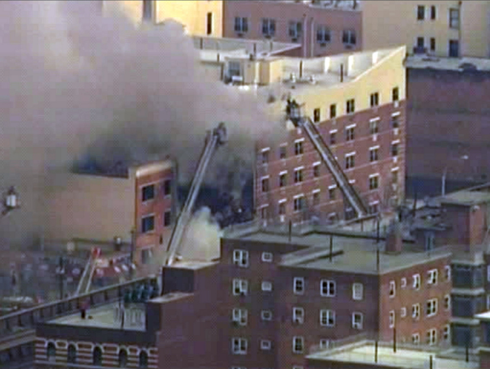 In this image taken from WABC-TV video, firefighters battle a blaze at the site of a reported explosion and building collapse in the East Harlem neighborhood of New York on Wednesday.