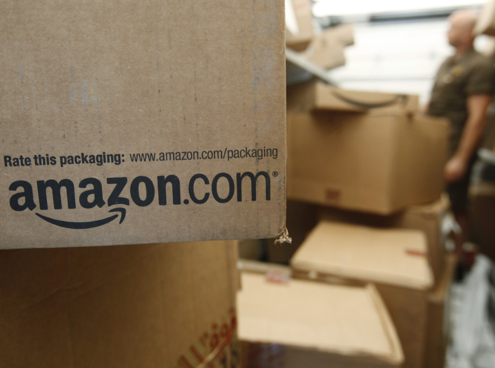 An Amazon.com package awaits delivery by UPS in Palo Alto, Calif. Amazon is raising the price of its popular Prime shipping and streaming video service to $99 per year, while also improving its selection of TV shows and movies.