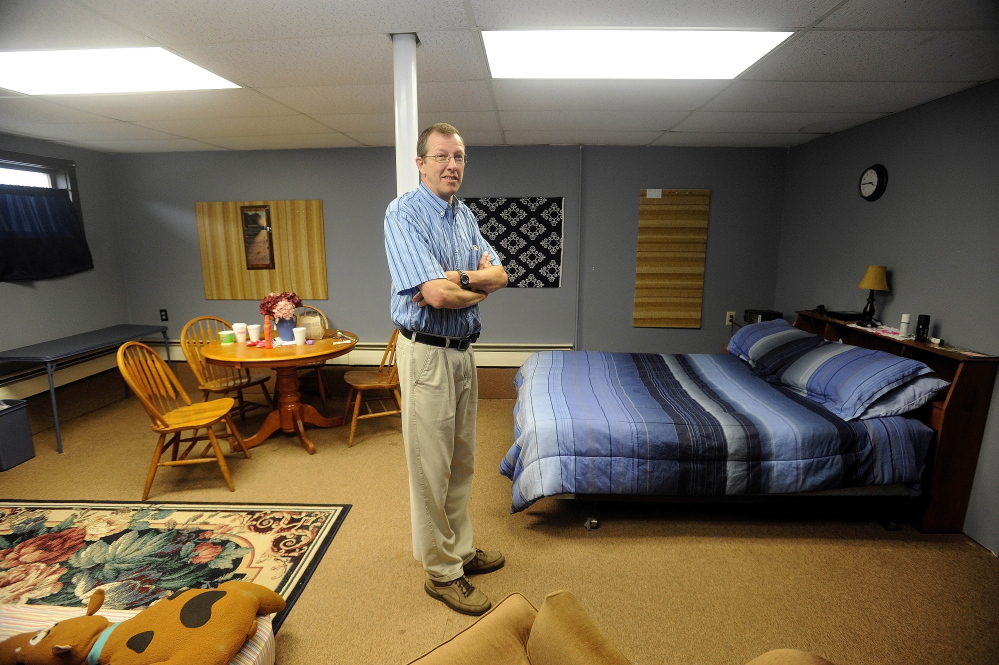 SHELTER: Steve Bracy, pastor of Living Waters Assembly of God Church and vice president of Western Maine Homeless Outreach, stands in the only private room at the church. The basement of the 547 Wilton Road church in Farmington has been renovated to help handle the needs of homeless families.