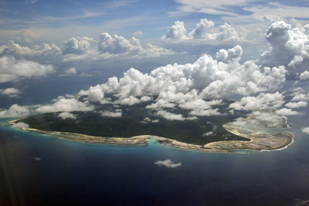 In this 2005 file photo, clouds hang over the North Sentinel Island, in India’s southeastern Andaman and Nicobar Islands. India used heat sensors on flights over hundreds of uninhabited Andaman Sea islands Friday, and will expand its search for the missing Malaysia Airlines jet farther west into the Bay of Bengal, officials said.