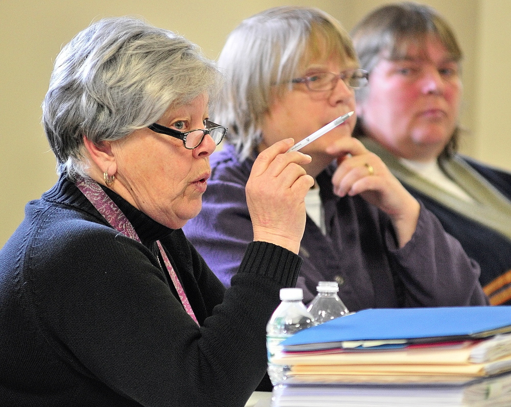 Answers: Jane Hubert, chairwoman of the Pittston Board of Selectmen, answers a question from a resident Saturday during debate at the Town Meeting in the Pittston Consolidated School. Fellow board members Vicki Kelley and Mary Jean Ambrose are at right.