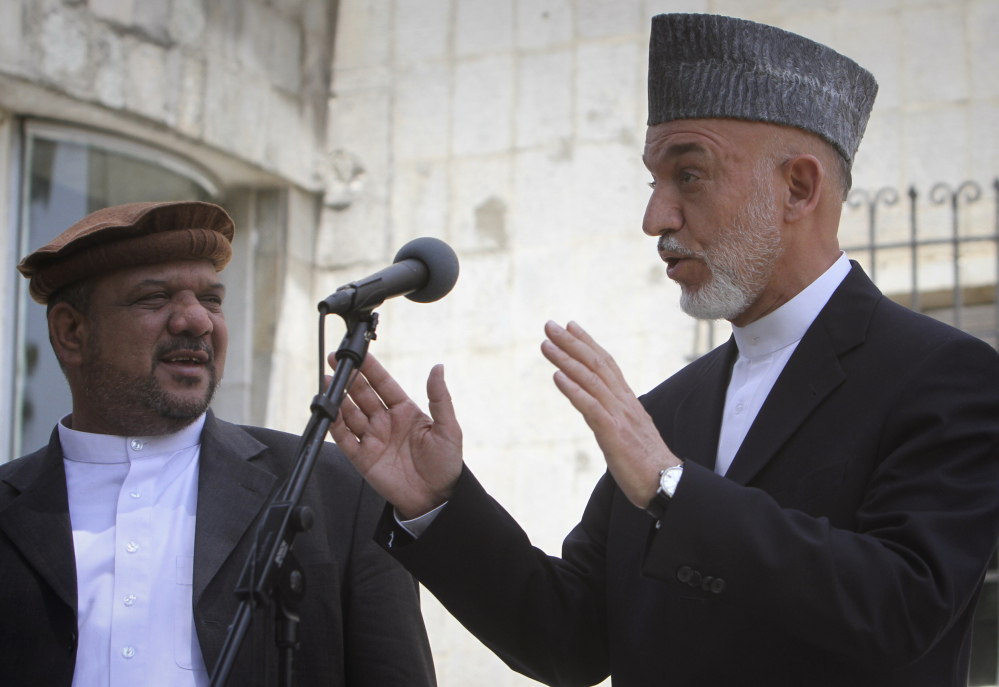 Afghan President Hamid Karzai, right, who came into power in December 2001, will be replaced in the April 5 elections. Under Afghanistan’s constitution, Karzai is banned from seeking a third term.