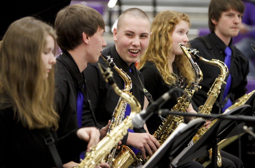 Westbrook Blue Blazes alto sax player Gary Sanville smiles at fellow band member Jacob Violette during the Maine State High School Instrumental Jazz Festival in Hampden on Saturday. Members of the Blue Blazes jazz band got a standing ovation for their performance.