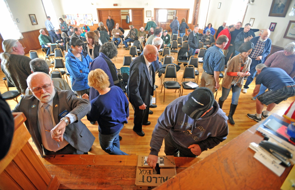Thinking inside the box: Residents of Benton cast their ballots during a vote on whether to establish a tax increment financing district Saturday during the Town Meeting at the Benton Grange.