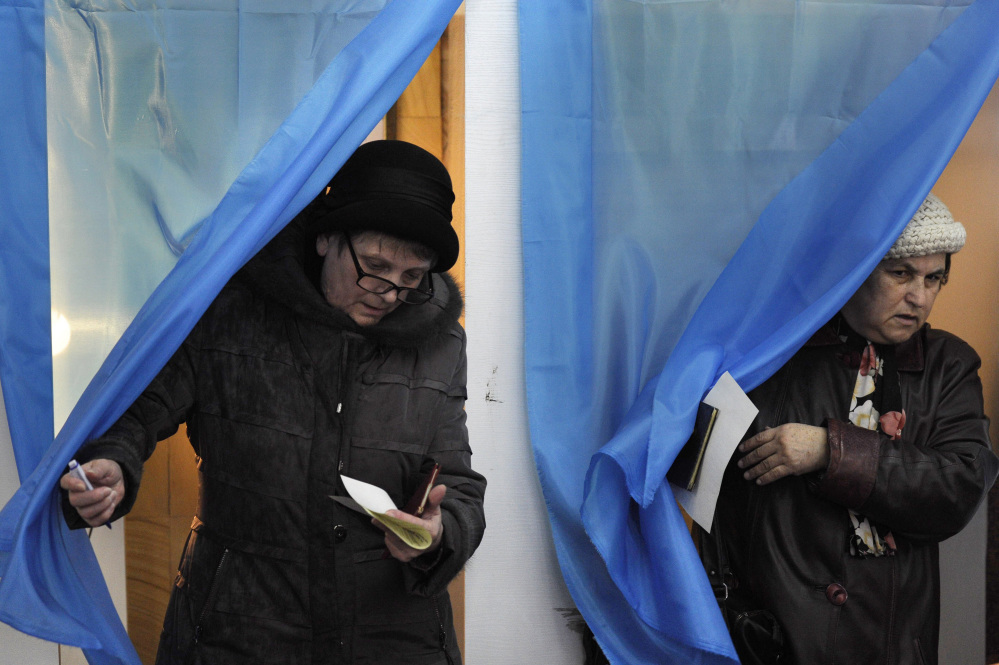 Women exit polling booths during the Crimean referendum in Sevastopol, Ukraine, on Sunday.