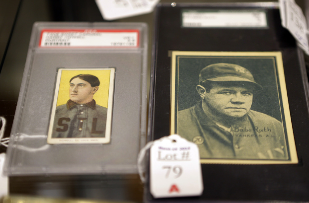 Baseball cards of major leaguers Harry Howell, left, and Babe Ruth displayed at the Saco River Auction House in Biddeford.