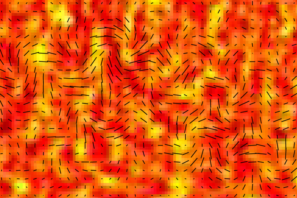 This image provided by the BICEP2 Collaboration shows slight temperature fluctuations, indicated by variations in color, of the cosmic microwave background of a small patch of sky and the orientation of its polarization, shown as short black lines. Researchers say since the cosmic microwave background is a form of light, it exhibits all the properties of light, including polarization. The changes in a particular type of polarization, indicated here, are theorized to be caused by gravitational waves. These waves are signals of an extremely rapid inflation of the universe in its first moments.
