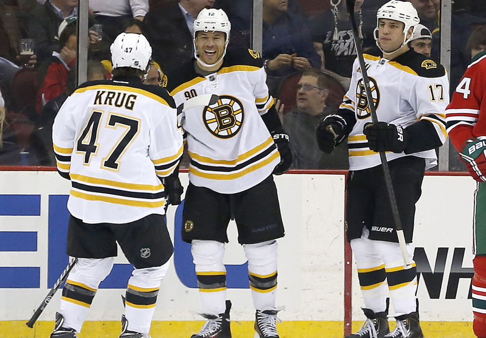 Boston’s Torey Krug, left, Jarome Iginla, center, and Milan Lucic celebrate Iginla’s goal during a 4-2 win by the Bruins on Tuesday against the New Jersey Devils at Newark, N.J.