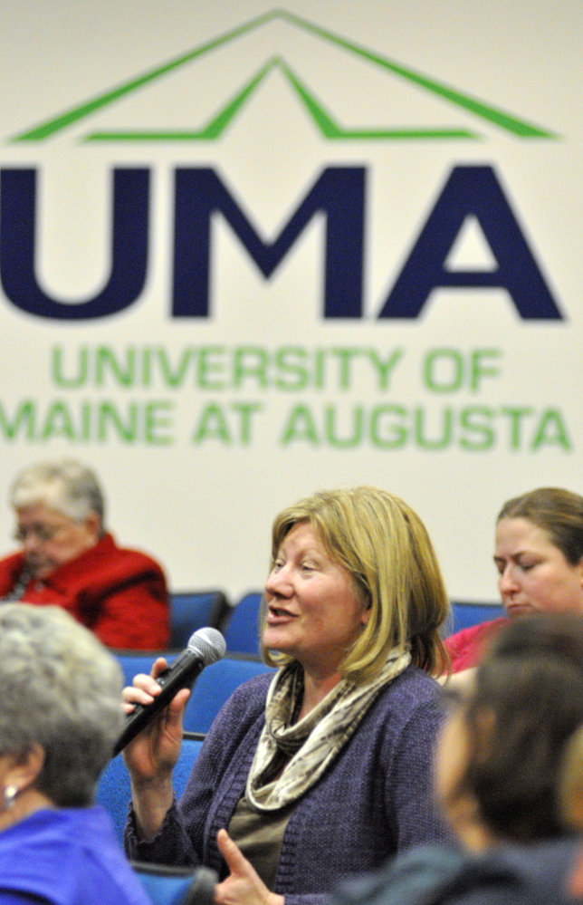 UMA cuts: Anita Jerosch, who works in the music program, asks a question about proposed budget cuts during a meeting on Wednesday in Jewett Hall at the University of Maine at Augusta.