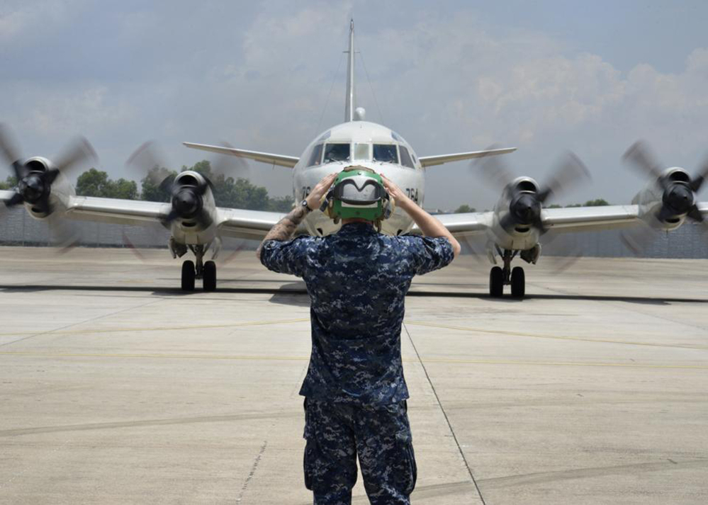 In this Monday, March 17, 2014 photo released by U.S. Navy, a sailor assigned to Patrol Squadron (VP) 46 prepares to launch a P-3C Orion before its mission to assist in search and rescue operations for Malaysia Airlines Flight 370 in Kuala Lumpur, Malaysia. New radar data from Thailand gave Malaysian investigators more potential clues Wednesday, March 19 for how to retrace the course of the missing Malaysian airliner, while a massive multinational search unfolded in an area the size of Australia. Cmdr. William Marks, a spokesman for the U.S. Navy’s 7th Fleet, said finding the plane was like trying to locate a few people somewhere between New York and California.