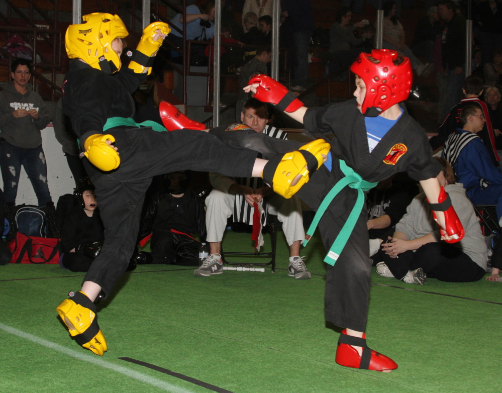 GETTING READY: Huard’s Martial Arts students Zachary Bean, 11, of Sidney point fights with Cameron Audet, 12, of Winslow during the 2013 Battle of Maine Martial Arts Championships. Hundreds of martial artists from around New England and Canada will be competing in this weekend’s Battle at Sukee Arena in Winslow on Saturday from 10 a.m. to 5 p.m.