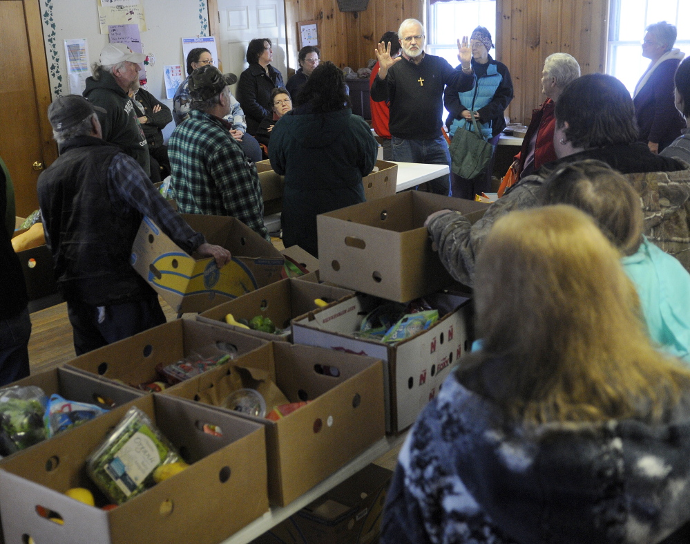 CLOSING: Pastor Sam Richards tells customers Tuesday at the East Winthrop Baptist Church Food Ministry that Hannaford will no longer give to food pantries unaffiliated with Good Shepherd Food bank.