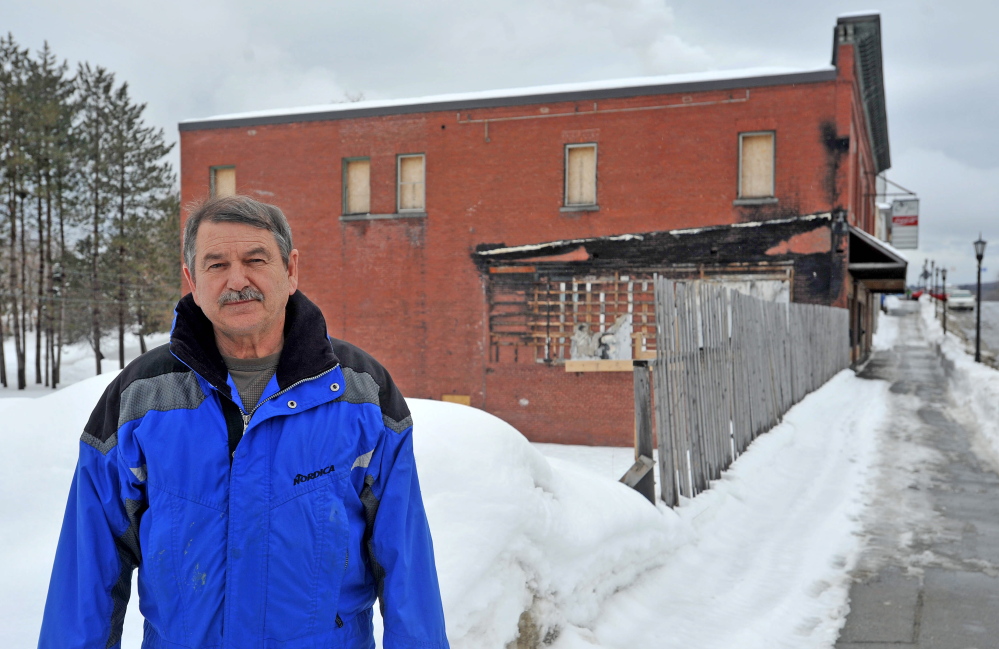 FILLING A HOLE: Bob Hagopian, owner of Economy Trophy, stands near the open space left behind from fire two years ago on Main Street in Madison on Thursday.