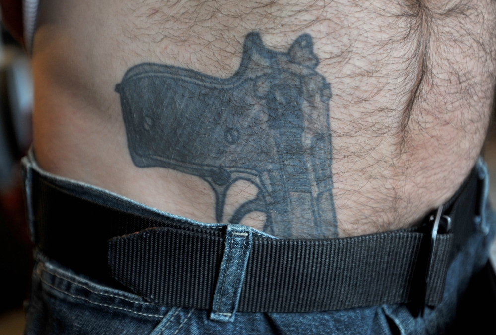 NOT LOADED: The tattoo of a 9-mm pistol that appears to be tucked in to the pants of Michael Smith prompted a police response at his Norridgewock home on Tuesday. The incident touched off a national media frenzy and online comments about gun rights, civil liberties and police actions.