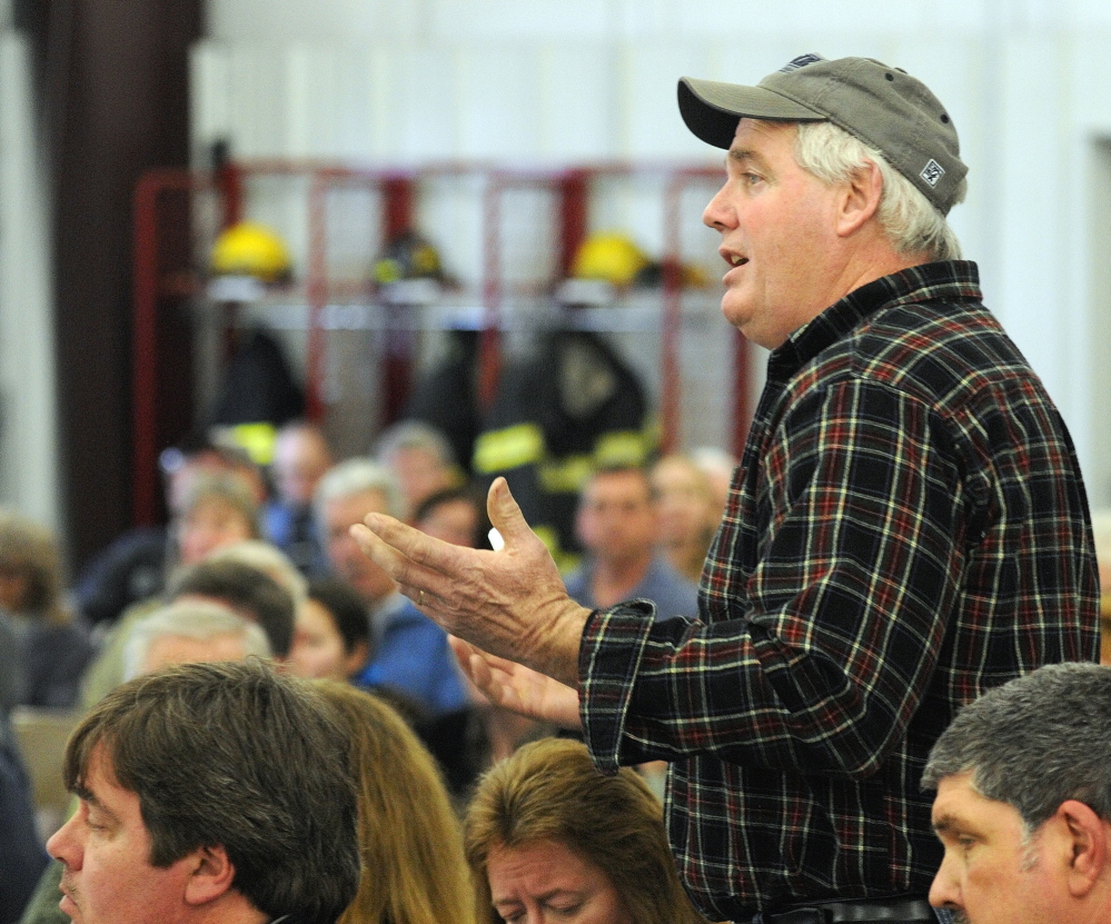 West Gardiner town meeting: Road commissioner Gary Hickey answers questions during debate about a warrant article on buying a new plow truck at the start of the 163rd West Gardiner Town Meeting on Saturday at the West Gardiner Fire Station.