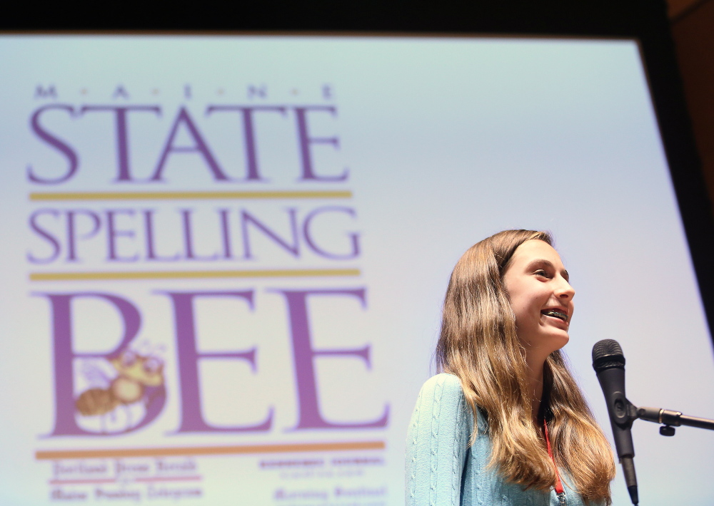Lucy Tumavicus, 14, of Portland stands at the microphone Saturday during an exceptionally long Maine State Spelling Bee. As champ, she’ll go on to the national competition in May.