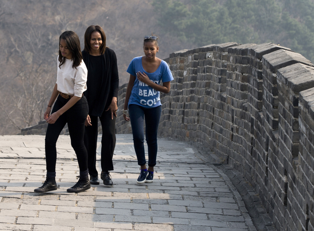 U.S. first lady Michelle Obama walks with her daughters Malia, left, and Sasha, right, as they visit the Mutianyu section of the Great Wall of China in Beijing on Sunday.
