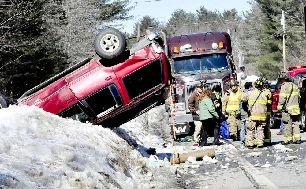 ROLLED: Fairfield police and firefighters responded to an accident that left an SUV upside down on a snowbank along Route 139 in Fairfield Center on Monday.