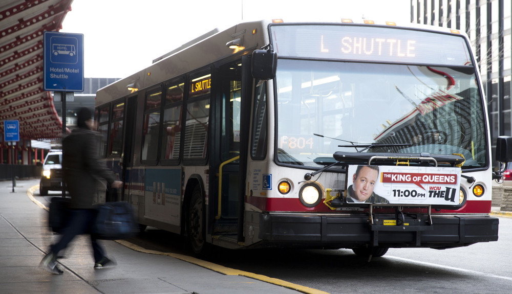 Passengers board a shuttle bus at O’Hare Airport after a Chicago Transit Authority train car derailed at the O’Hare Airport station.