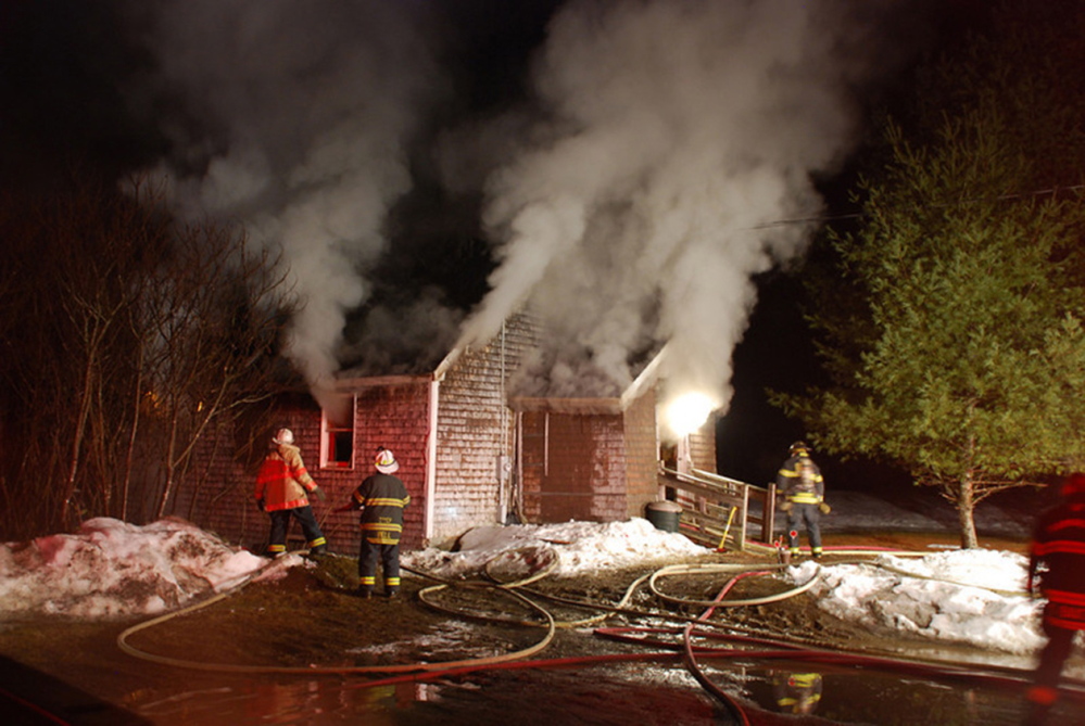 ON THE SCENE: Fire departments from Franklin County towns Chesterville, Farmington, Industry, New Sharon, Strong, Temple and Wilton all responded to this structure fire in March 2013. Franklin County’s fire departments are struggling to attract new volunteers and are considering a regional solution.