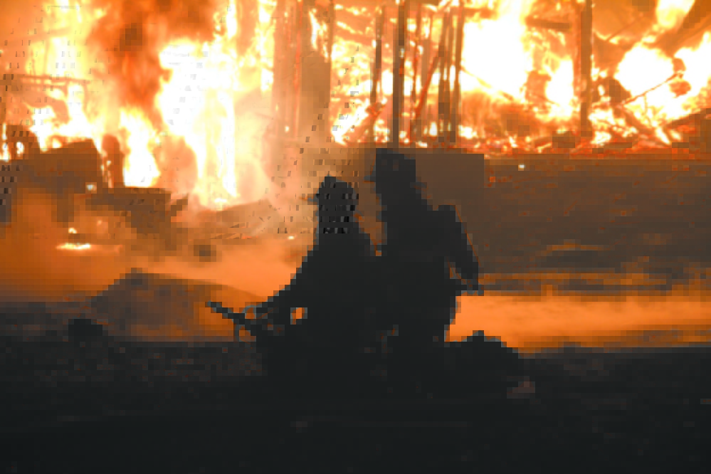 COMMUNITY EFFORT: Flames engulf a barn at Knowlton Corner Farm in Farmington in 2011. Franklin County towns are discussing forming a regional organization to assure towns have fire coverage in the face of declining numbers of volunteers.
