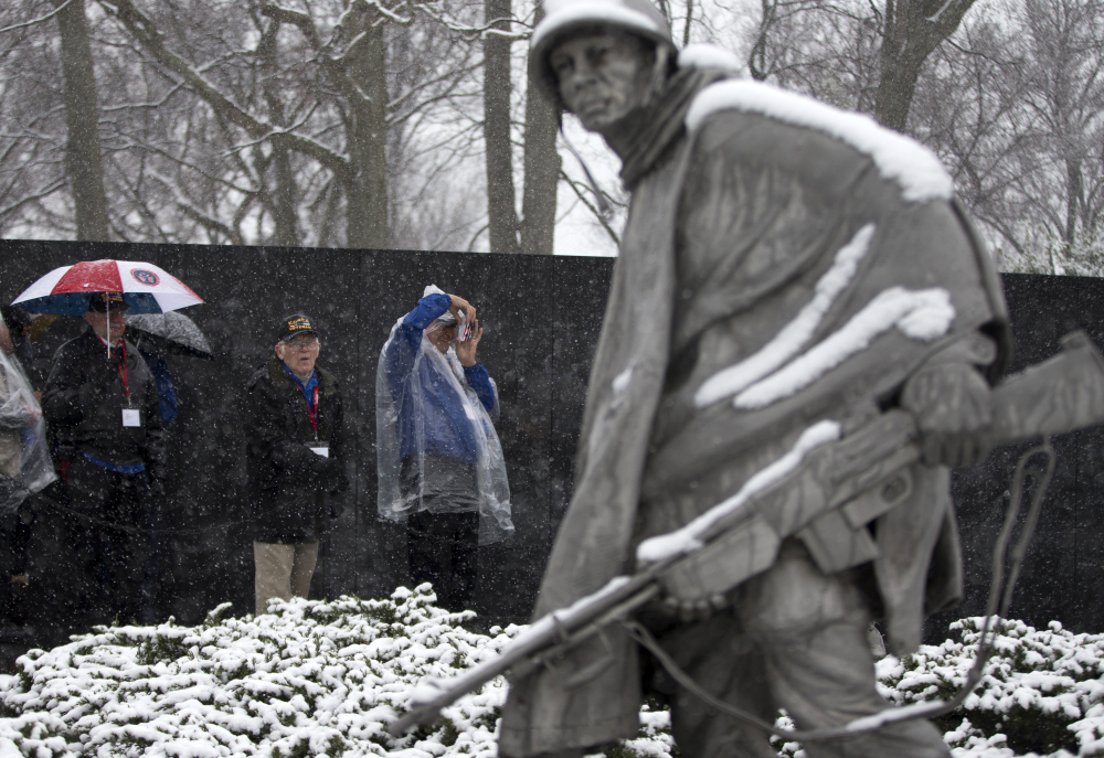 Visitors view the Korean War Memorial during a snowstorm in Washington on Tuesday.