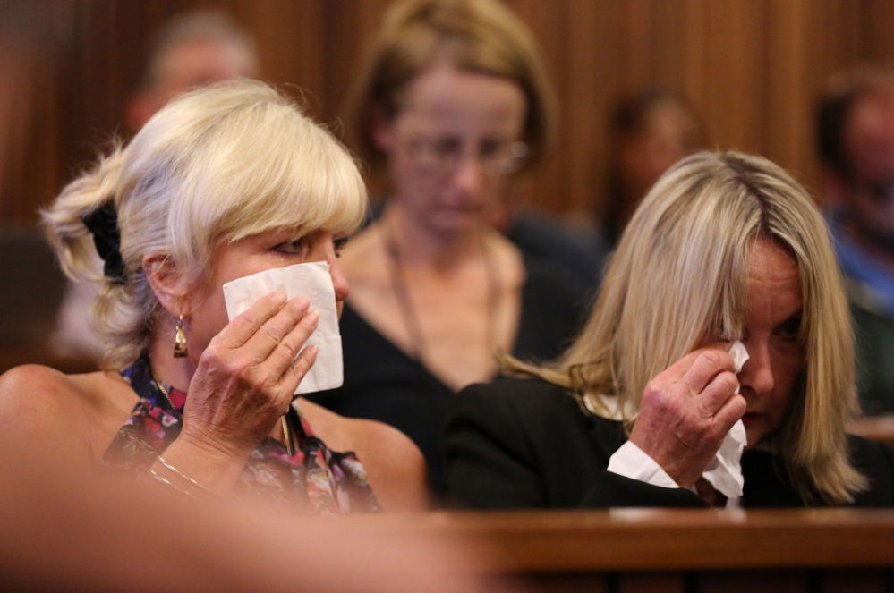 June Steenkamp, right, mother of the late Reeva Steenkamp, and family friend, Jenny Strydom, react during the murder trial of Oscar Pistorius, during cross questioning on mobile phone text messages between Pistorius and Steenkamp.