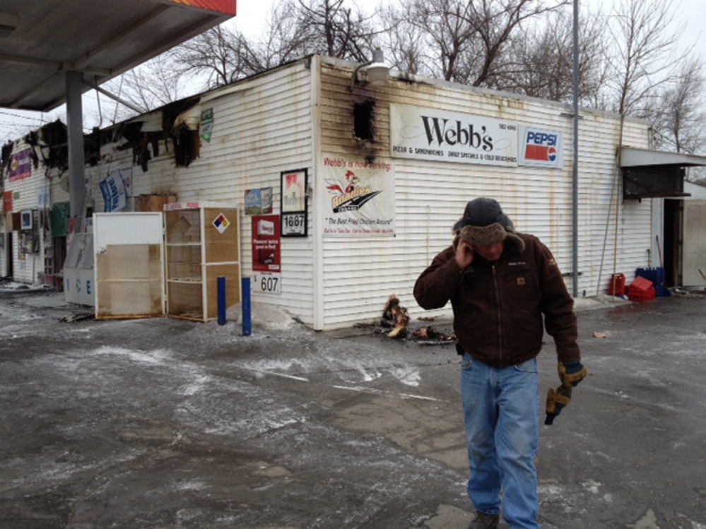 Taking stock: Webb’s Store owner Dan Kilmer speaks on the phone Wednesday morning after a fire destroyed the business overnight.