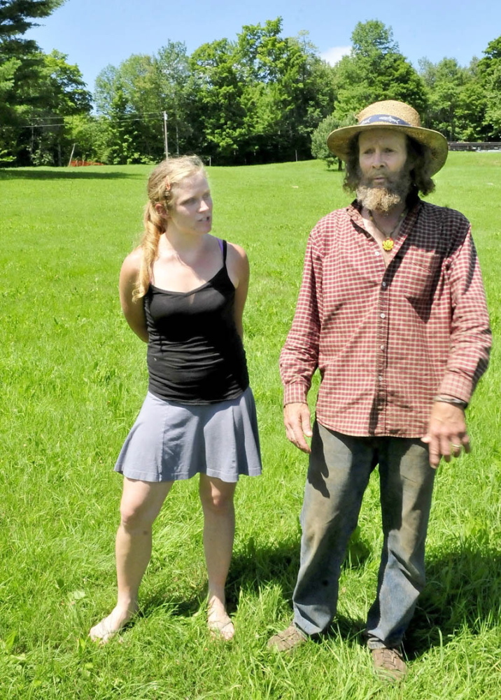UNWELCOME DEVELOPMENT: Starks residents Elizabeth Smedberg and Harry Brown speak in July 2013 in a field off Abijah Hill Road, directly below the proposed site of a celltower. Brown and his wife, Cindy, who live near the site, have appealed in Somerset County Superior Court the town’s August decision to allow the 195-foot tower.