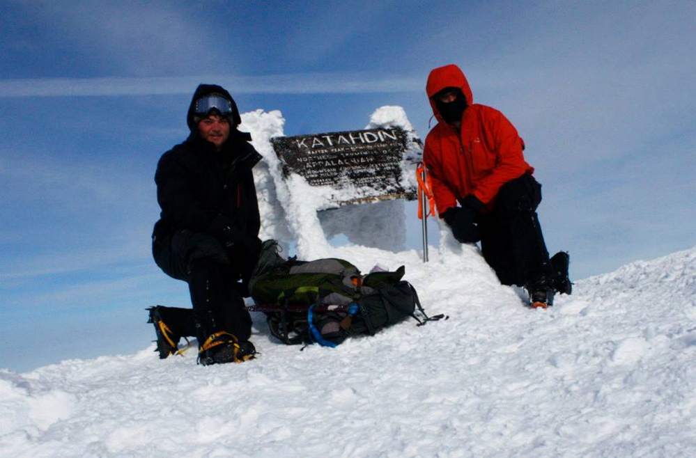 Tyler Heinrich, left, and Willoughby pose by the sign at Baxter Peak, which is the highest point of the Mount Katahdin