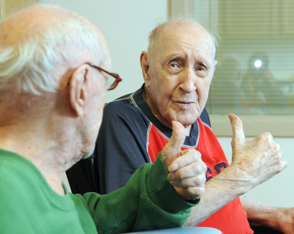 SO FAR, SO GOOD: Twin brothers Lawrence Binette, left, and Maurice Binette give each other a thumbs-up on Thursday at an early 100th birthday party at the Maine Veterans’ Home in Augusta.