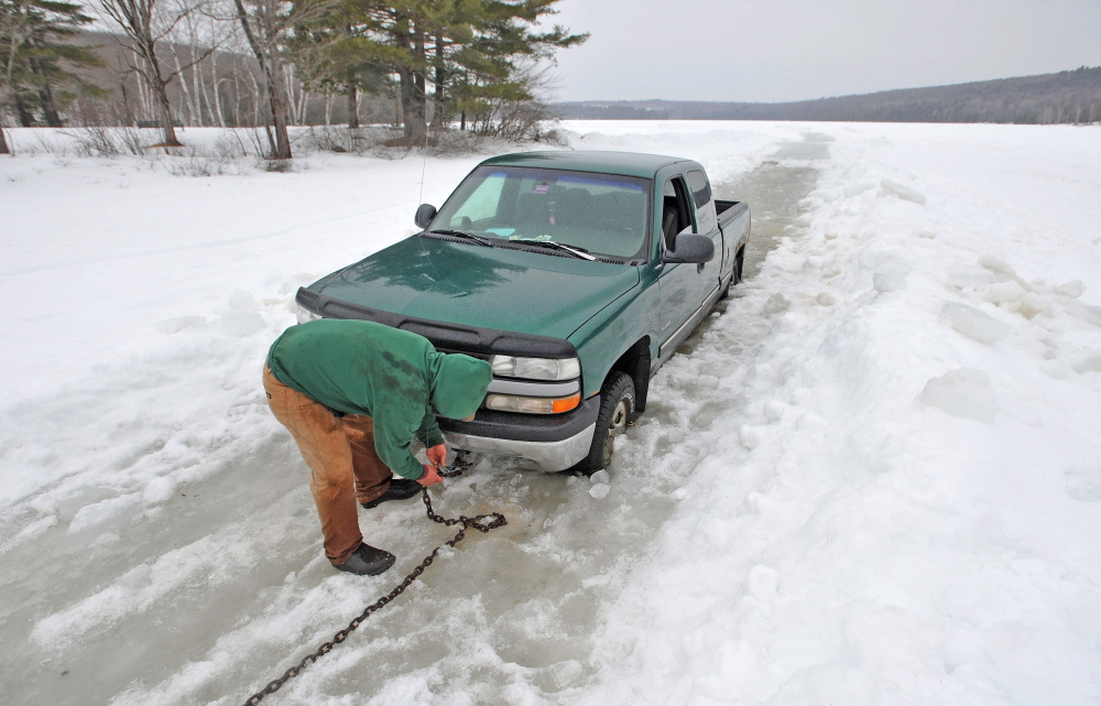 SOFT ICE: Steve Richardson, 28, of Clinton, tries to free his pickup truck Friday from Lake George in Canaan after trying to get his ice fishing shack off the ice ahead of an April 1 deadline. Richardson’s truck broke through about 2 feet of ice, coming to rest on another layer of ice and lake water.