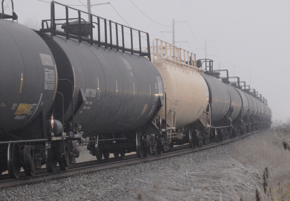 Black tank cars of the type used to transport crude oil from North Dakota head toward a refinery in Anacortes, Wash. Federal regulators say the industry hasn’t provided data requested months ago.