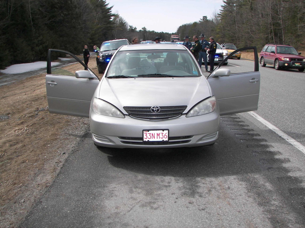 A vehicle is stopped on Interstate 295 Saturday morning. Two people were arrested in connection with a shooting on Cape Cod, Mass.