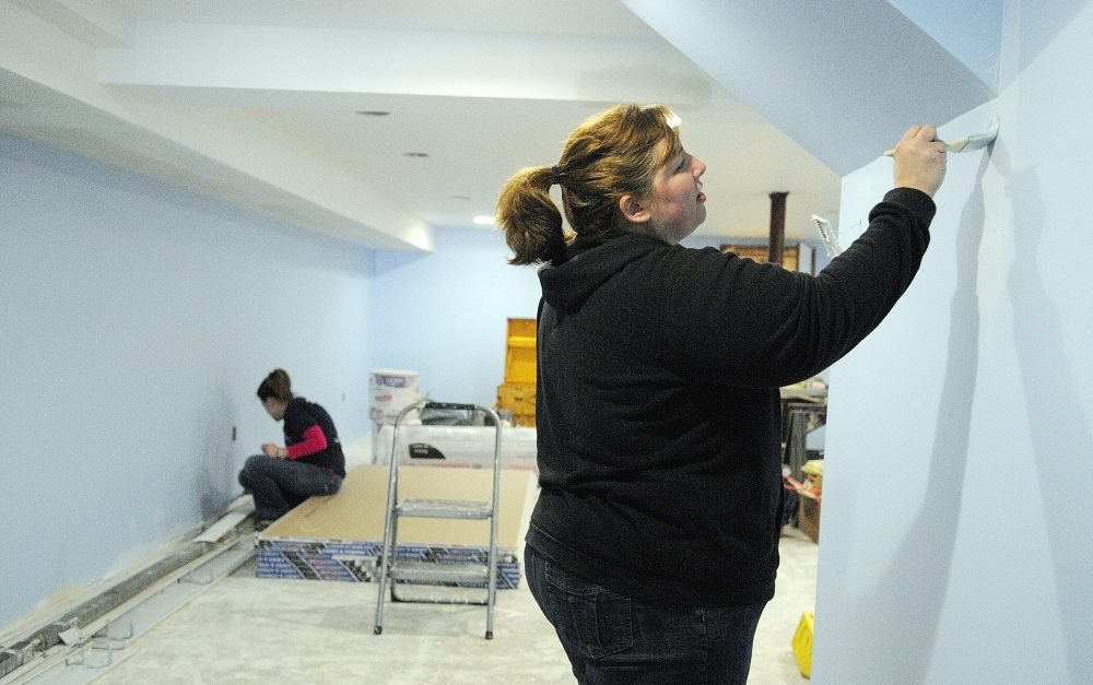 ANOTHER COAT, ANOTHER PURPOSE: Melanie Miller, left, and Kiley Perry paint walls in the nursery Wednesday at the new Kennebec Community Church in Augusta. The group recently bought the former St. Andrew Church building off South Belfast Avenue, on the east side of Augusta.