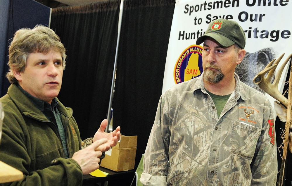 Vanguard of the opposition: David Trahan, executive director of the Sportsman’s Alliance of Maine, left, and Matt Whitegiver answer questions about the bear hunt referendum during an interview Saturday at the Maine Sportsman’s Show in the Augusta Civic Center.