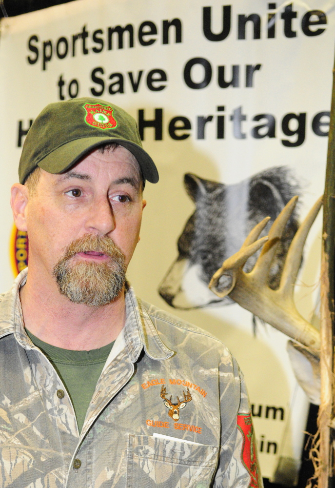 Jobs issue: Bear hunting guide Matt Whitegiver answers a question about the pending bear hunt referendum during an interview Saturday at the Maine Sportsman’s Show in the Augusta Civic Center.